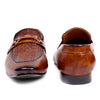 Pair of brown leather loafers with a decorative buckle on a white background